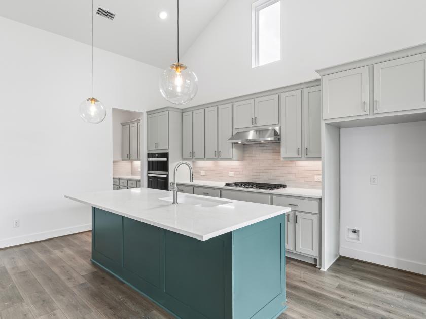 Kitchen with two-tone cabinetry and ample storage space