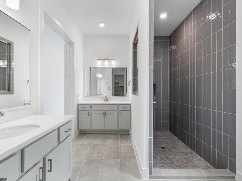 Spa-inspired primary bathroom with expansive shower and dual vanities