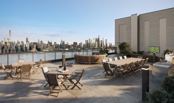 The rooftop terrace features lounging areas, an outdoor TV, and grilling stations