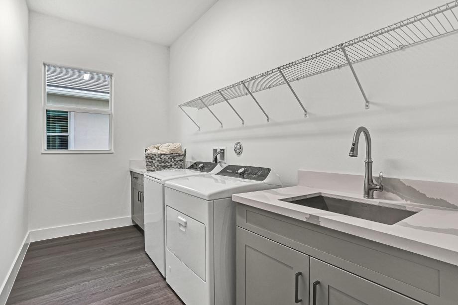 Laundry room with cabinets and sink