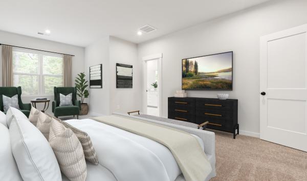 Serene primary bedroom suite with seating area