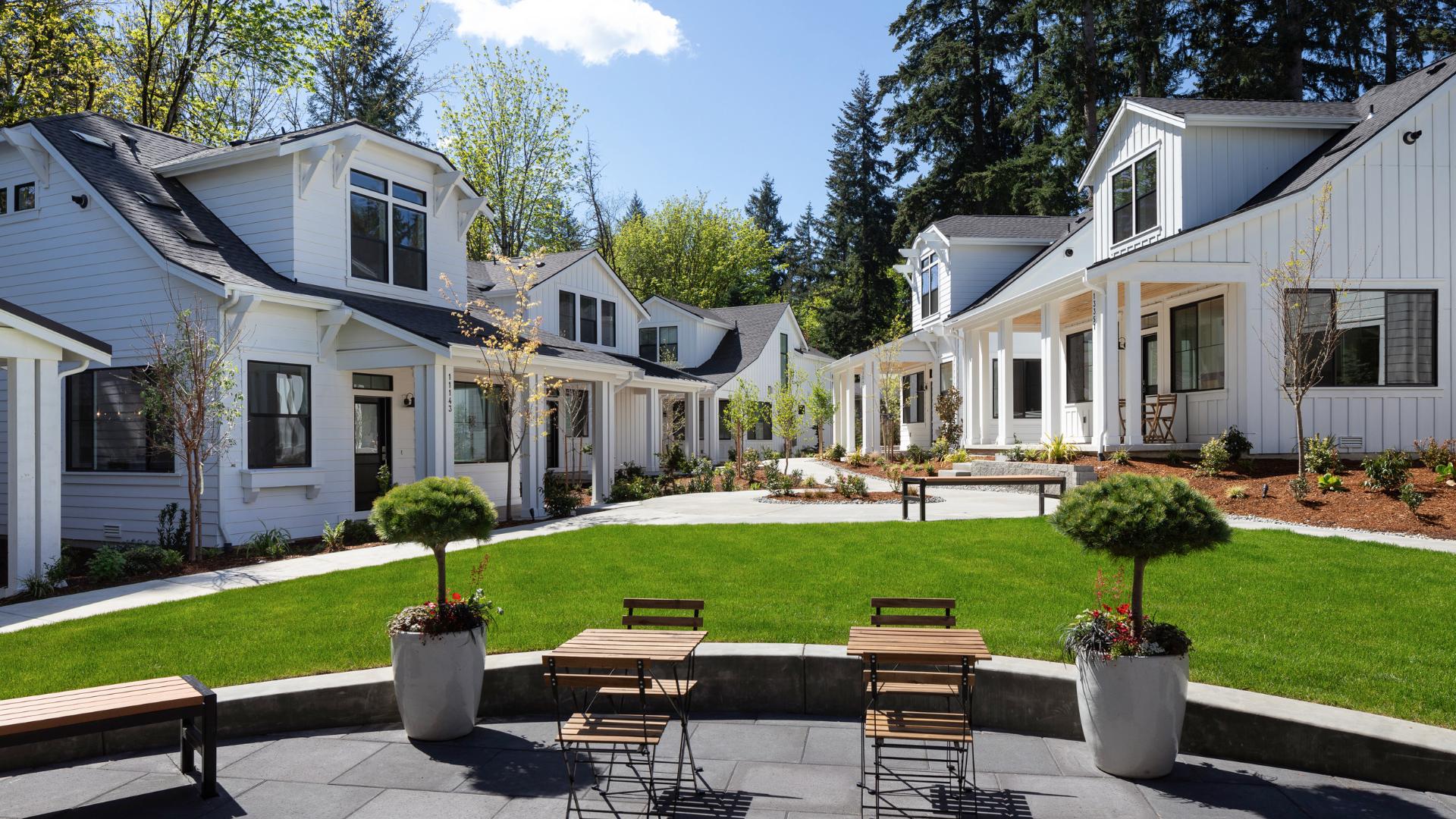 White cottage-style homes overlooking the Center Green and clubhouse terrace