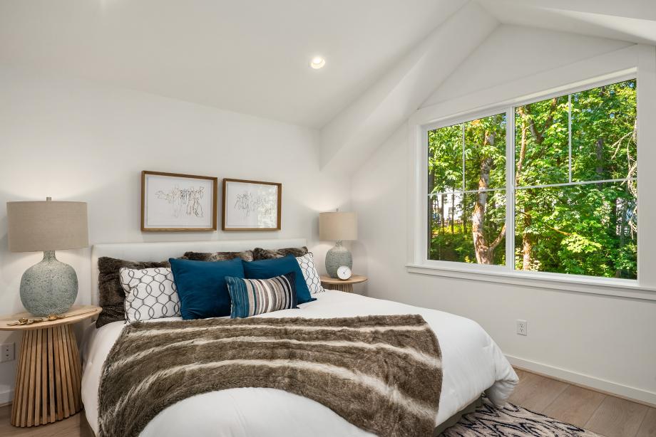Primary bedroom offers a vaulted ceiling