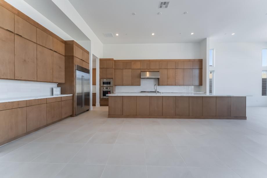 Stunning upgraded kitchen with oversized island and slab door, stacked cabinets