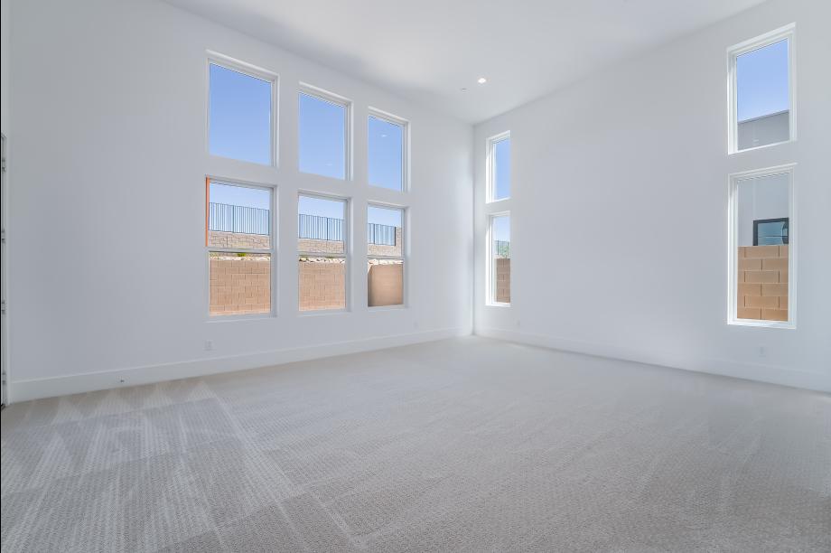 Expansive primary bedroom with abundant windows