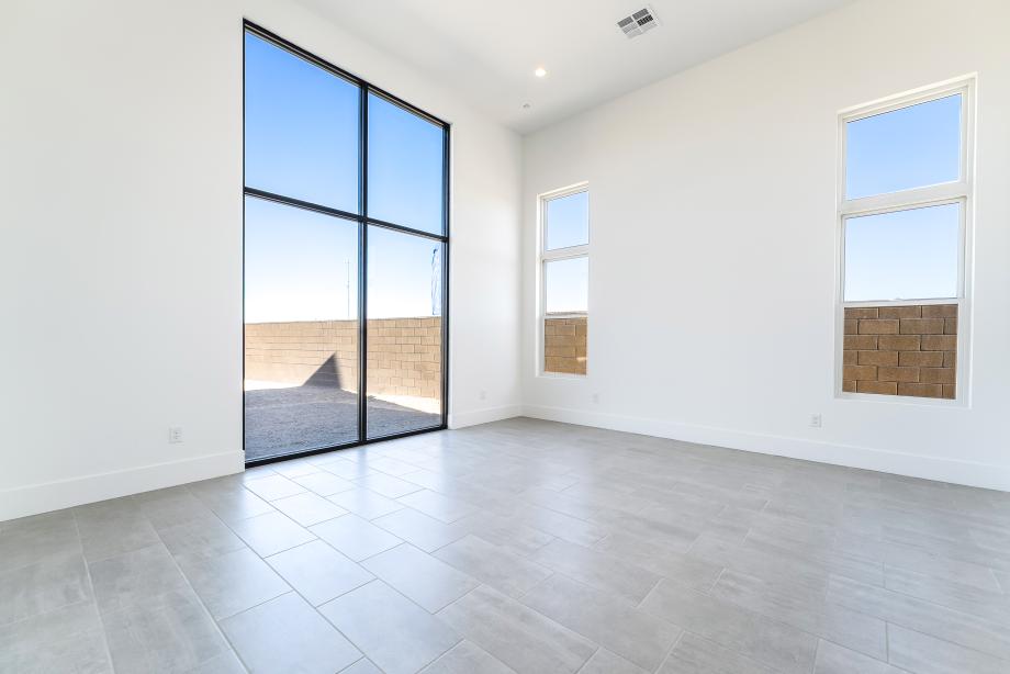 Opulent primary bedroom with storefront windows