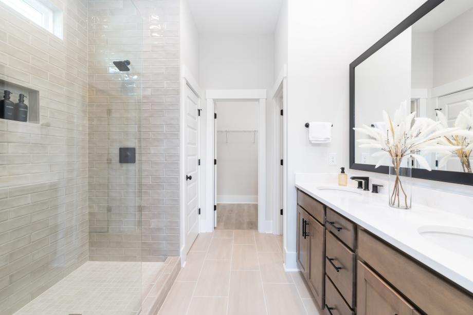 Gorgeous primary bathroom with a dual-sink vanity and luxe walk-in shower