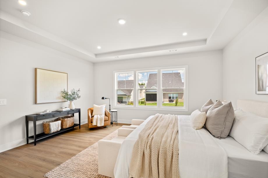 Large primary bedroom with plentiful natural light