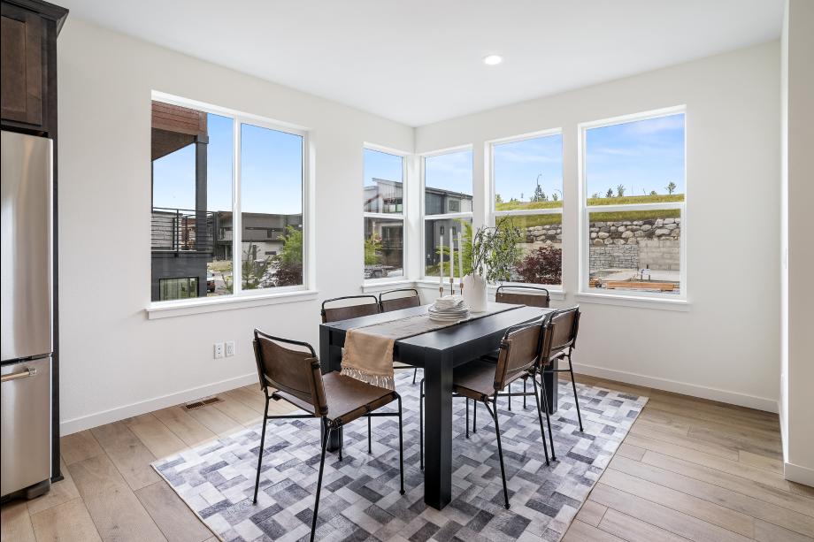 Corner windows in the dining area draw light throughout the main living level