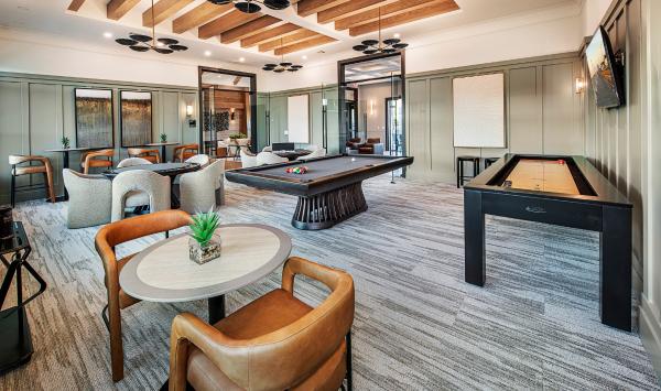 A vibrant game room with shuffleboard, pool table, and card tables for endless entertainment