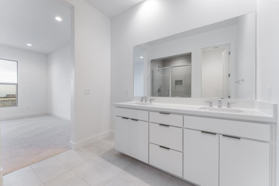 Relaxing primary bath with dual vanities