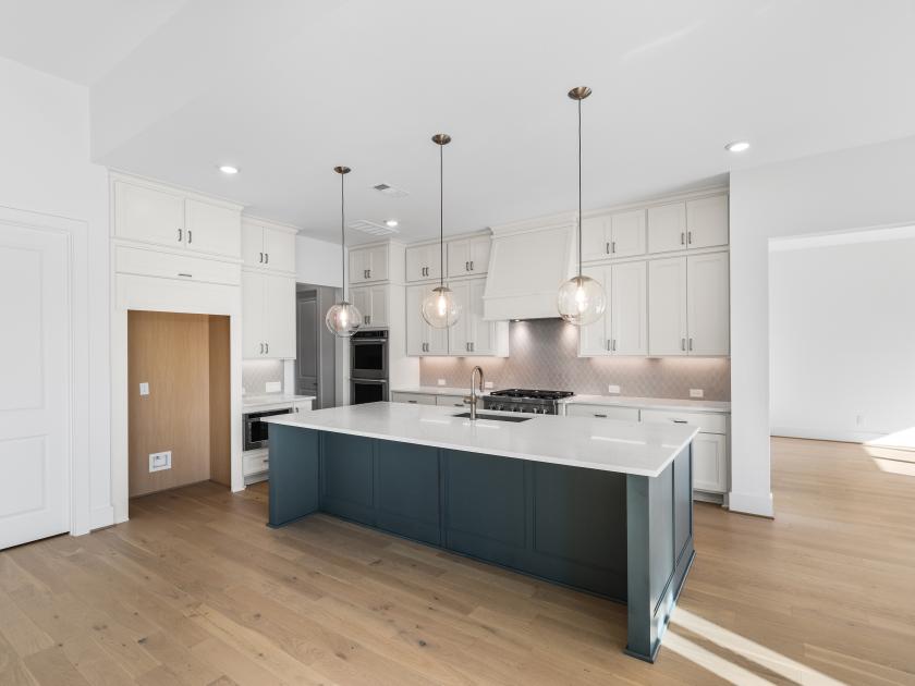 Beautifully painted kitchen island with upgraded fixtures
