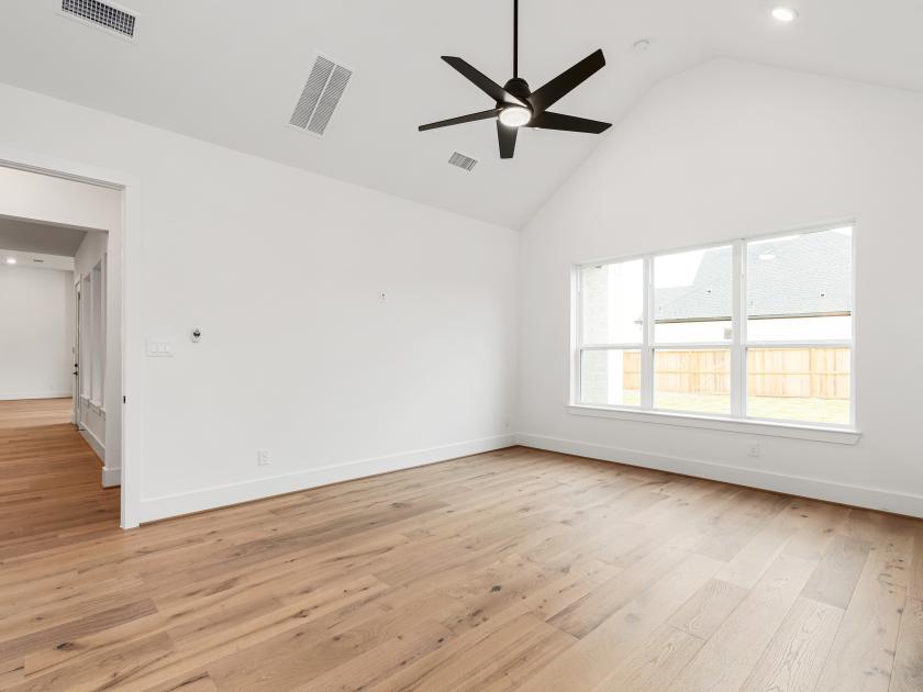 Primary bedroom with vaulted ceilings