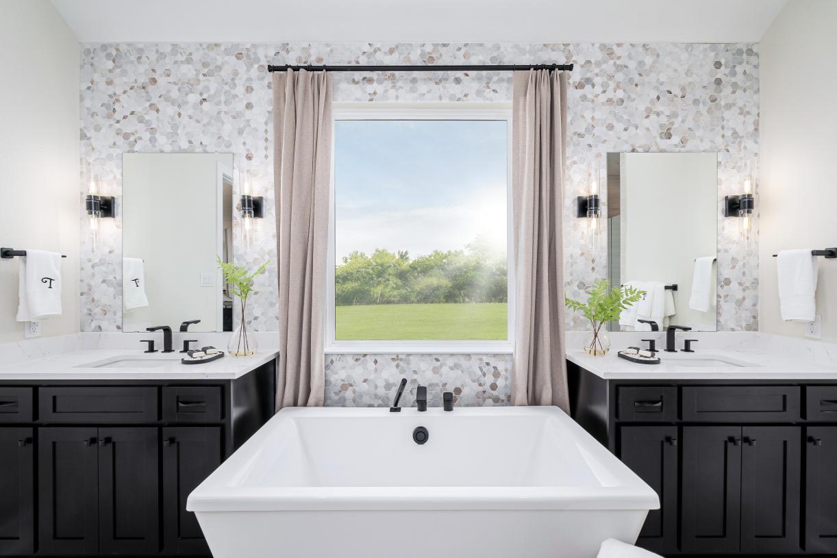 Luxurious primary bathroom with dual vanities