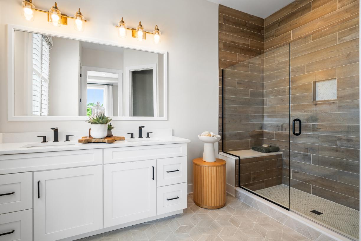 Spa-like primary baths feature a luxe shower with seat