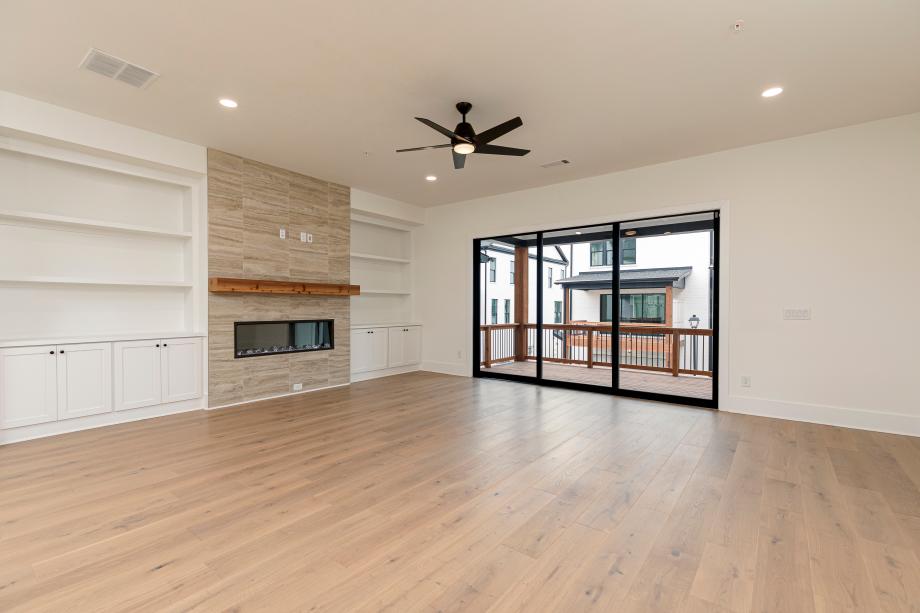 Open-concept great room connects to covered deck