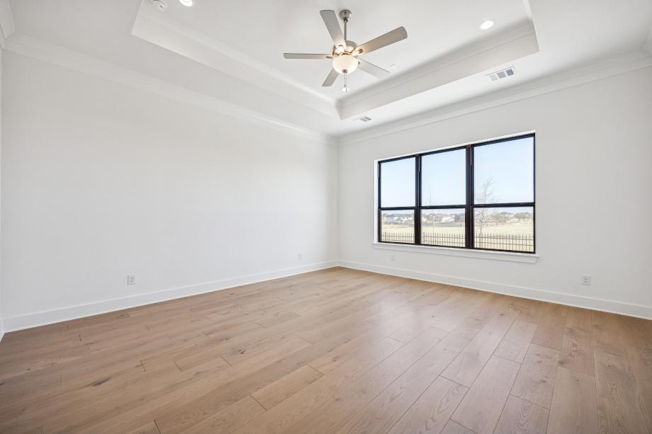 Private primary bedroom complemented by a tray ceiling
