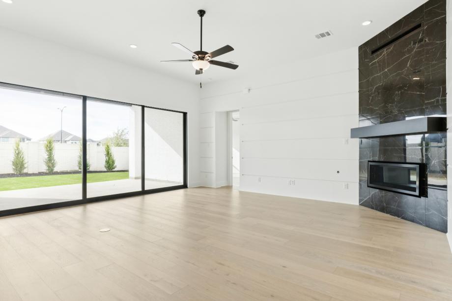 Striking fireplace with sun-filled multi-slide door