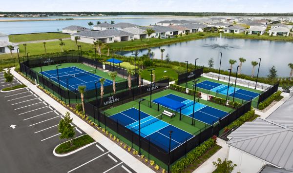 Tennis and Pickleball courts with nearby putting green and game lawn