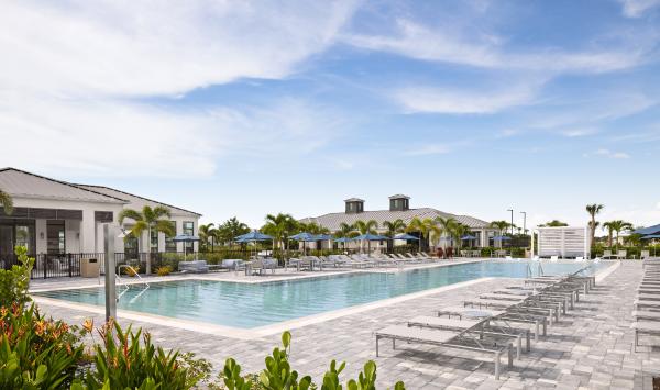 Resort-style swimming pool with sun shelf and cabanas