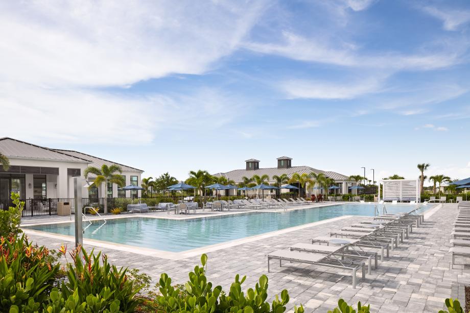 Resort-style swimming pool with sun shelf and cabanas