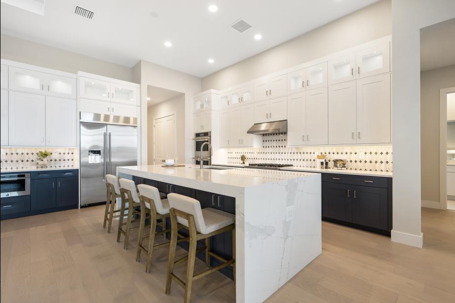 Gourmet kitchen with large center island and abundant storage
