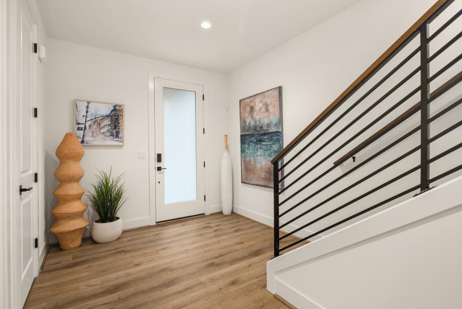 Entry foyer with contemporary metal stair railing