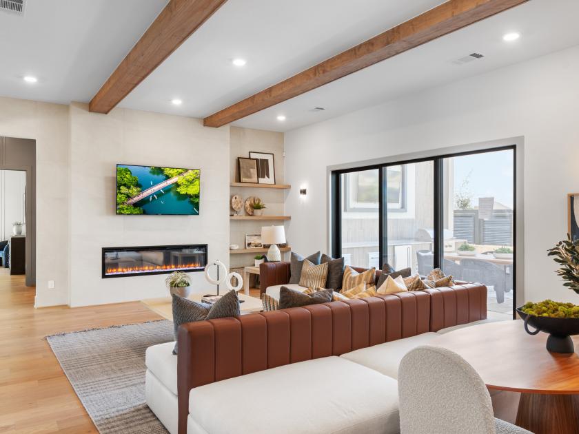 Great room with beams and a fireplace