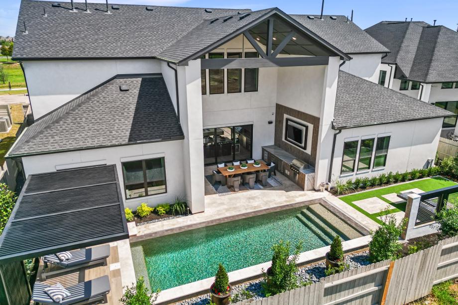 Backyard with a two-story outdoor patio and a pool