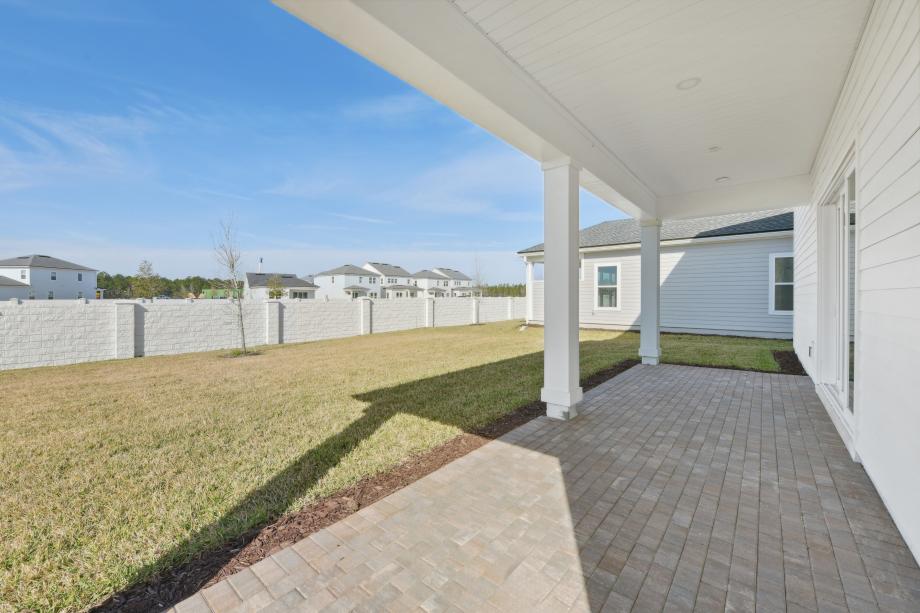 Extended covered lanai ideal for outdoor living, dining, and entertaining