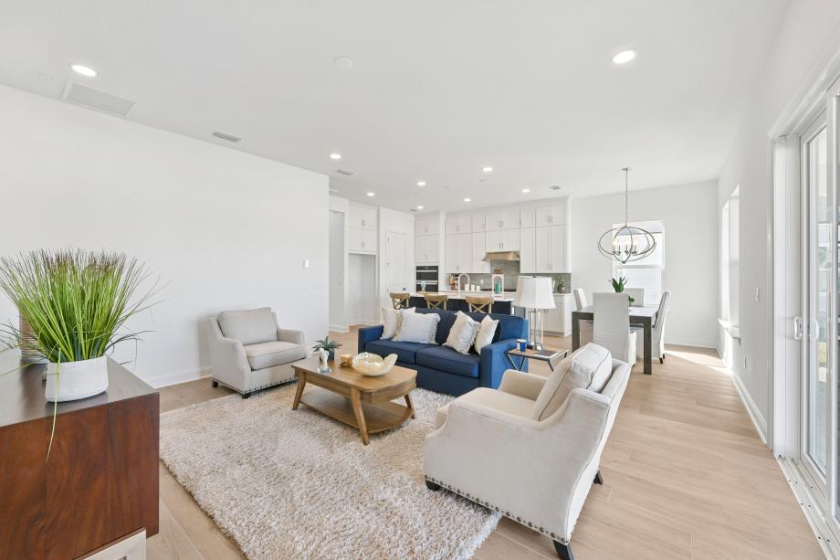 Open-concept great room with views of the kitchen, casual dining, and outdoor living