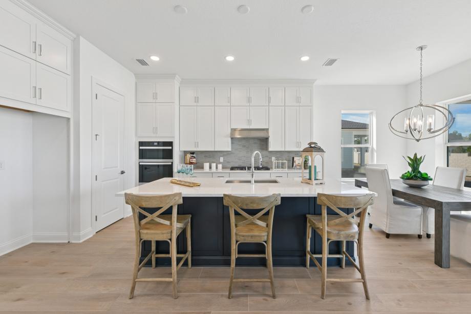 Stunning kitchen with stacked white cabinets and a large center island