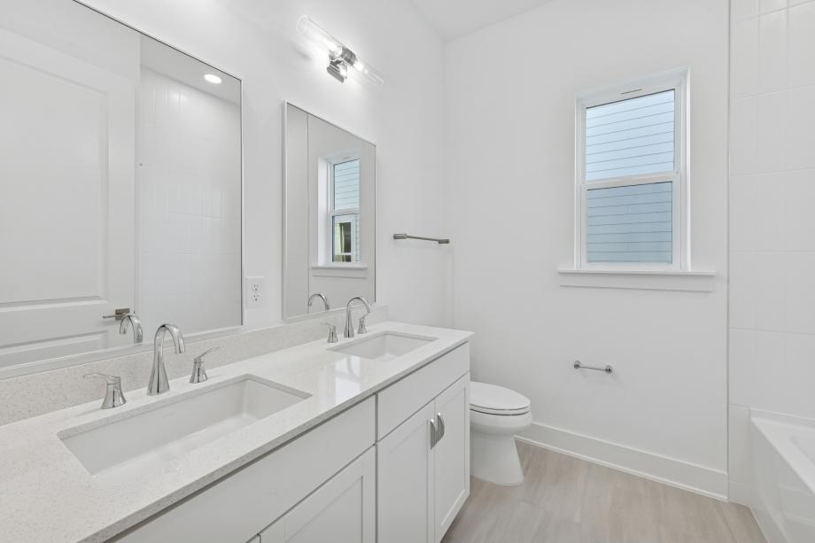 Secondary bathroom with a tub/shower combination with tile surround