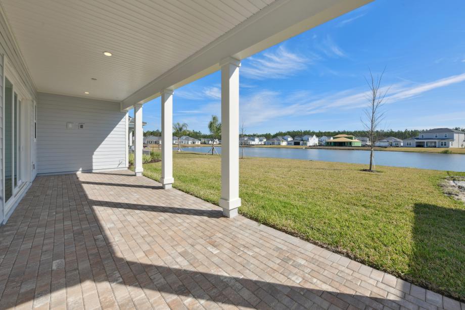 Extended covered lanai ideal for outdoor living, dining, and entertaining
