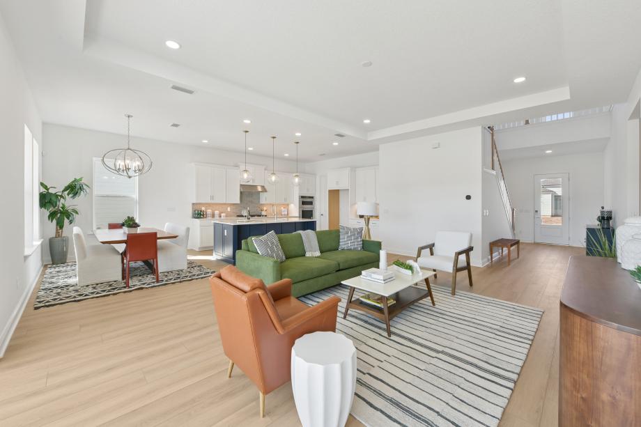 Large great room with views of the kitchen and casual dining area beyond