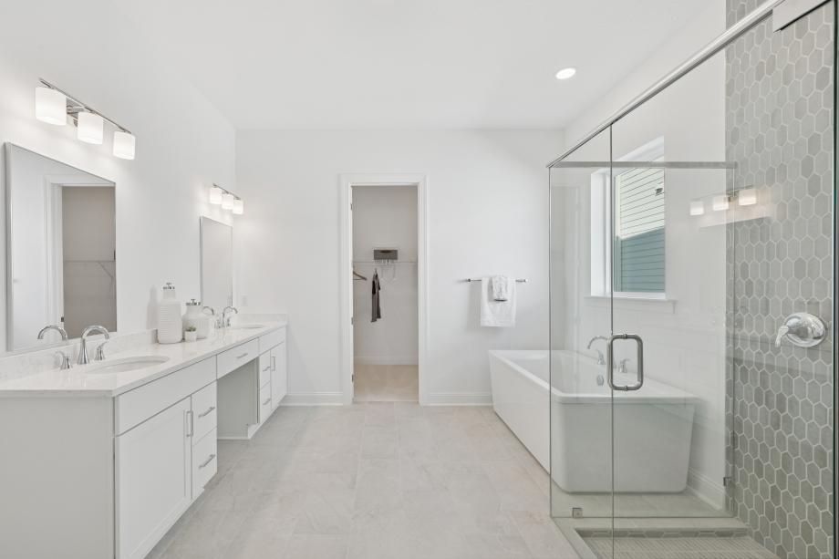 Spa-like primary bathroom with freestanding soaking tub and large walk-in shower