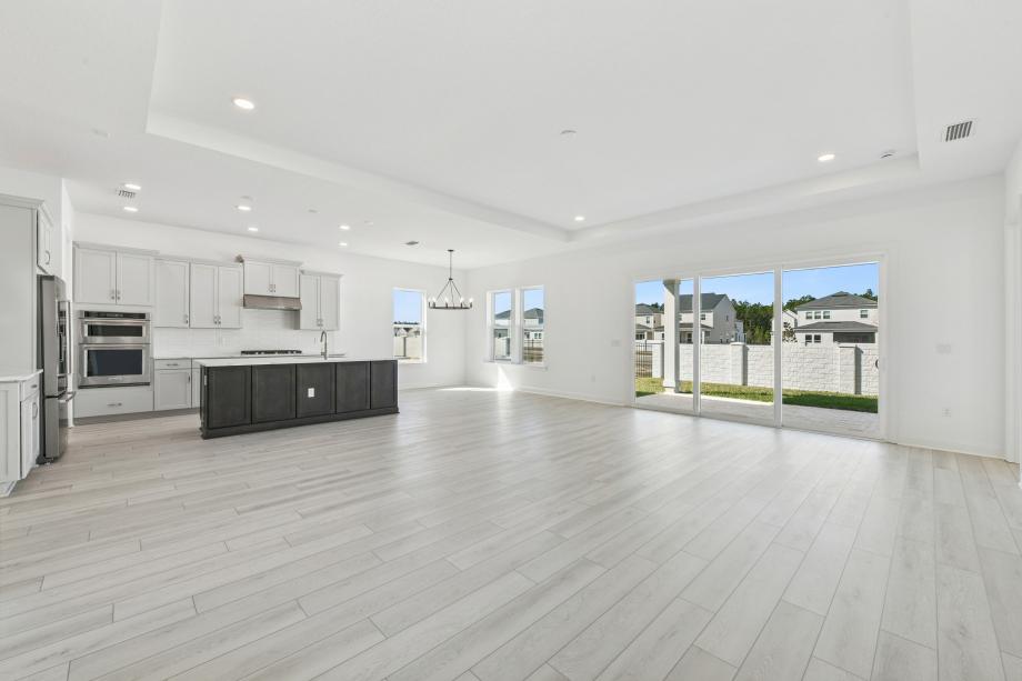 Large great room with multi-sliding glass door connecting indoor-outdoor living