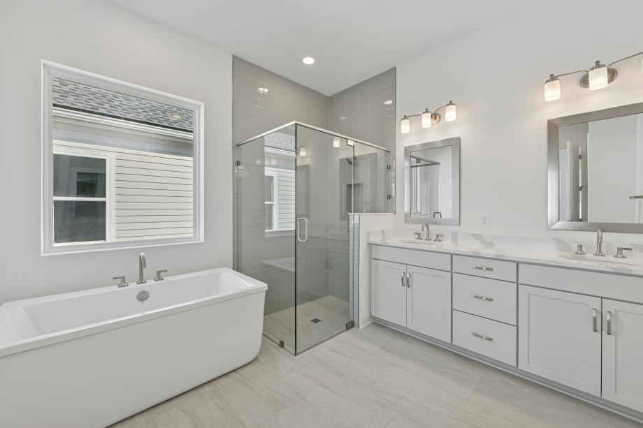 Spa-like primary bathroom with a large walk-in shower and freestanding bath