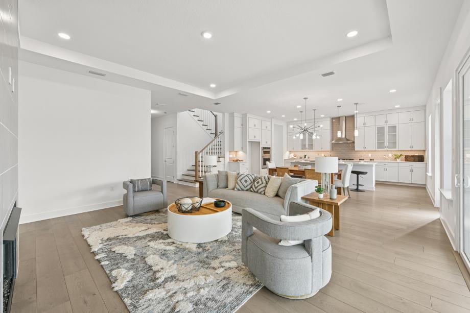 Spacious great room with ample natural light and a fireplace