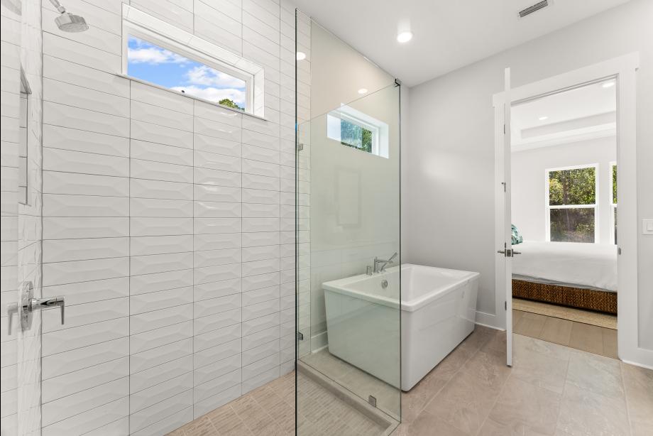 Spa-like primary bath with glass-enclosed shower and refined details