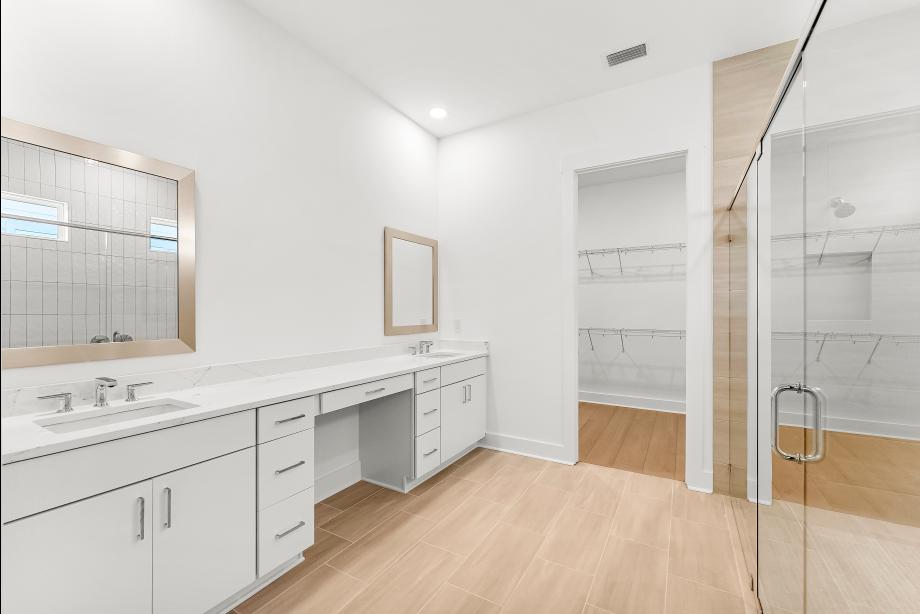Spa-like primary bathroom with a large walk-in shower and dual-sink vanity