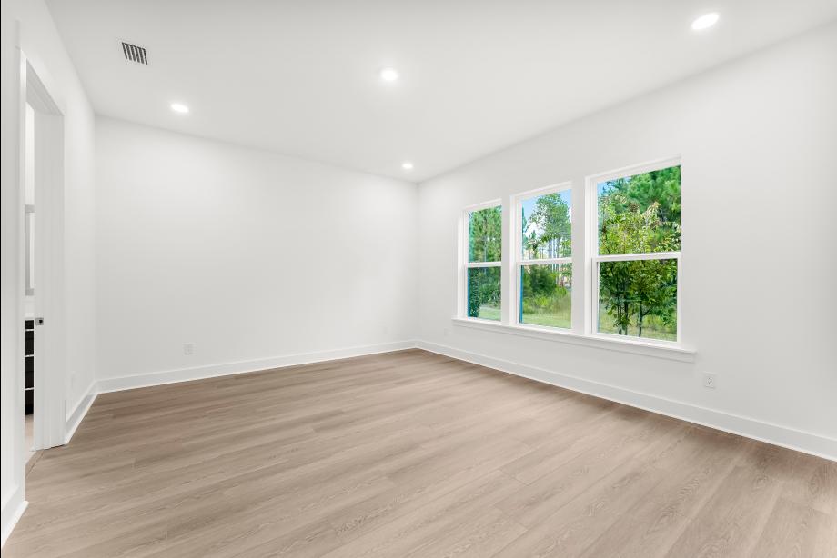 Large primary bedroom suite with ample natural light