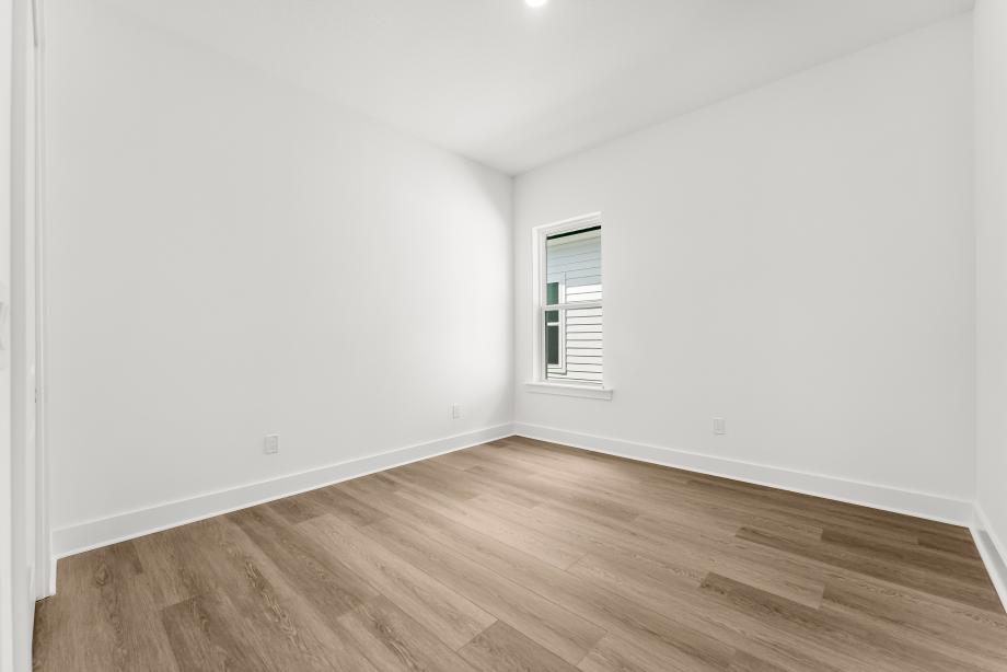 Secondary bedroom suite with a walk-in closet