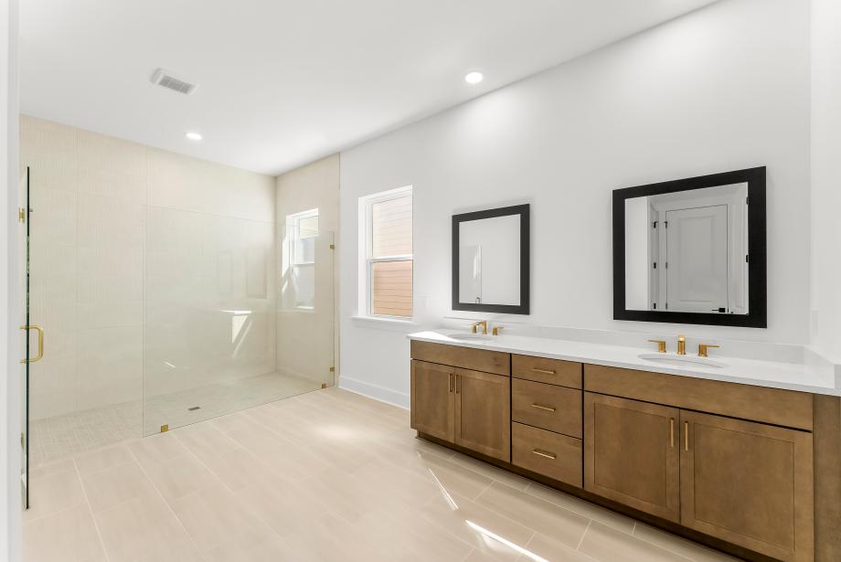 Spa-like primary bathroom with a large walk-in shower and dual-sink vanity