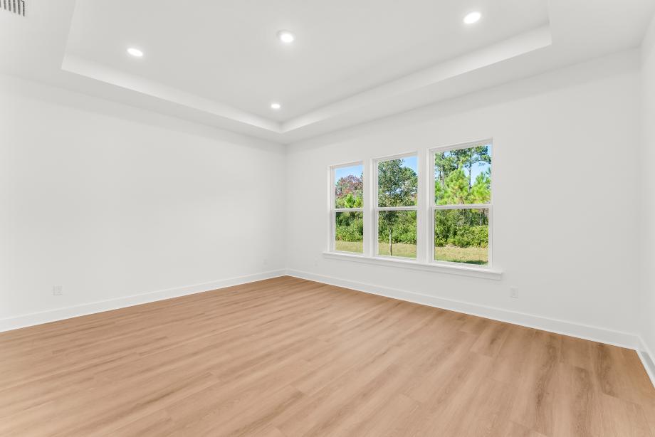 Large primary bedroom suite with ample natural light
