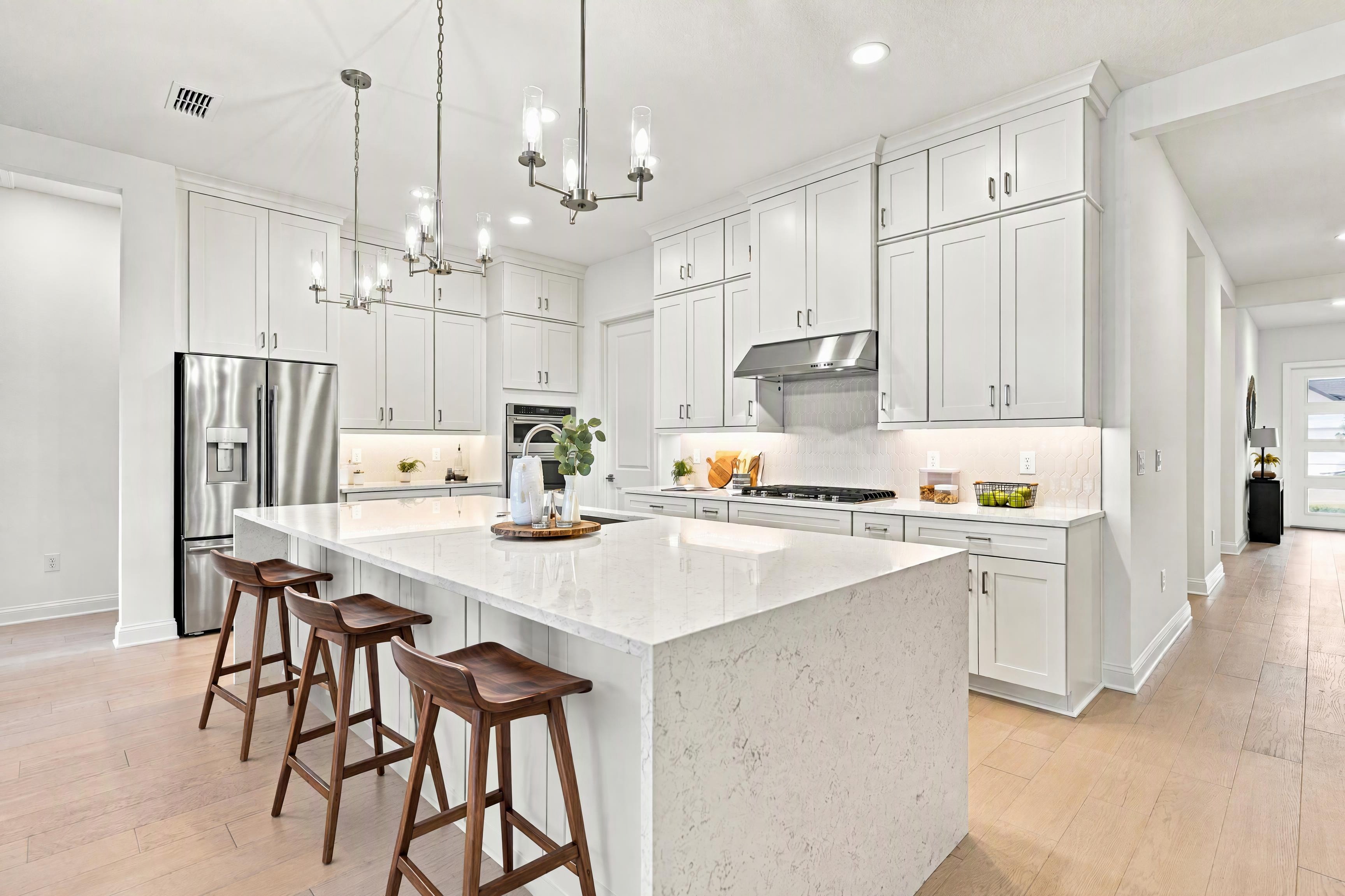 Well-appointed kitchen with expansive center island and abundant cabinetry