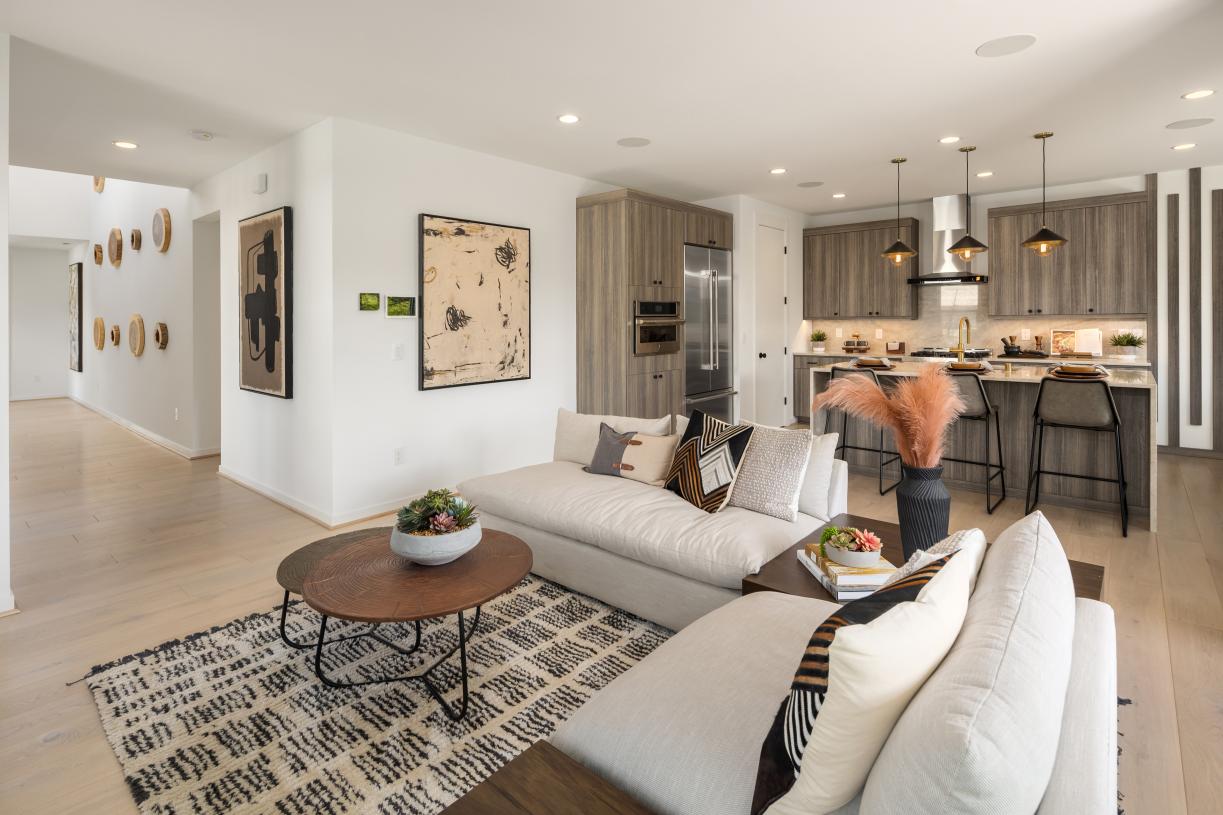 Great room and kitchen of the Tapps home design with a 2-story foyer beyond