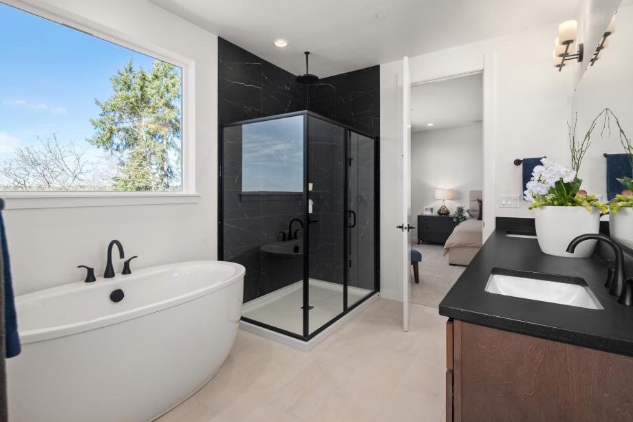 Primary bathroom features a freestanding tub, walk-in shower, and dual-sink vanity