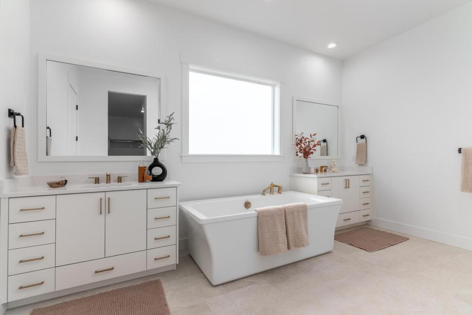 The primary bathroom suite is tucked away for a more intimate, private setting