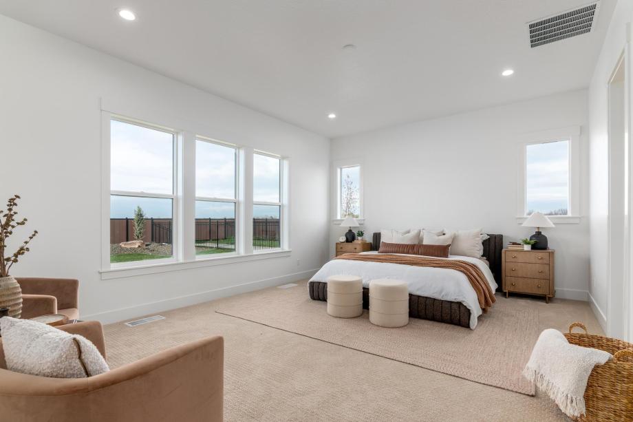 Spacious primary bedroom is a luxurious retreat